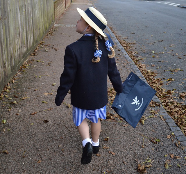 Girl walking school uniform- back to school